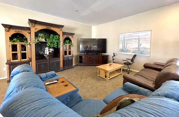 Spacious living room with comfortable seating and a large television.