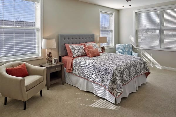 Bright, cozy private resident room with a bed and furniture