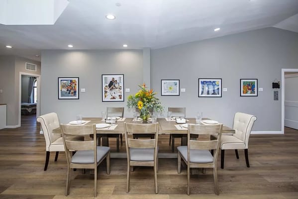 Bright dining area with a large table and flower centerpiece