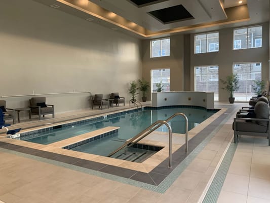 Indoor swimming pool area with seating