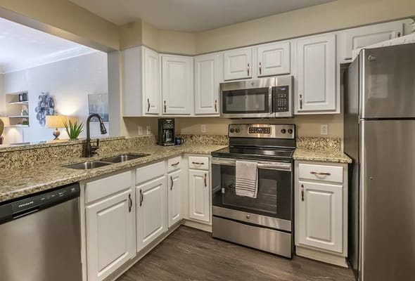 Stylish kitchen with stainless steel appliances and granite countertops