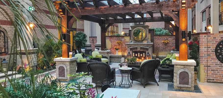 Indoor garden area with seating and a fireplace