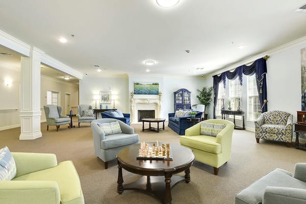 Bright common area with comfortable seating and chess set