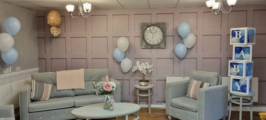 Common area decorated for a celebration with balloons