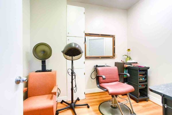 Hair salon area with chairs and styling equipment