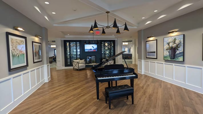 Interior shot of a common area with a piano