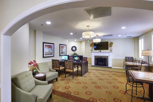 A well-decorated lounge area featuring comfortable seating and a fireplace.