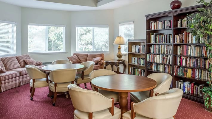 Cozy common area with seating and bookshelves