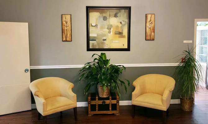 Cozy lounge area with yellow chairs and plants