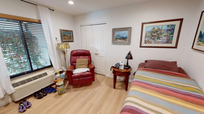 Cozy resident room with a colorful striped blanket