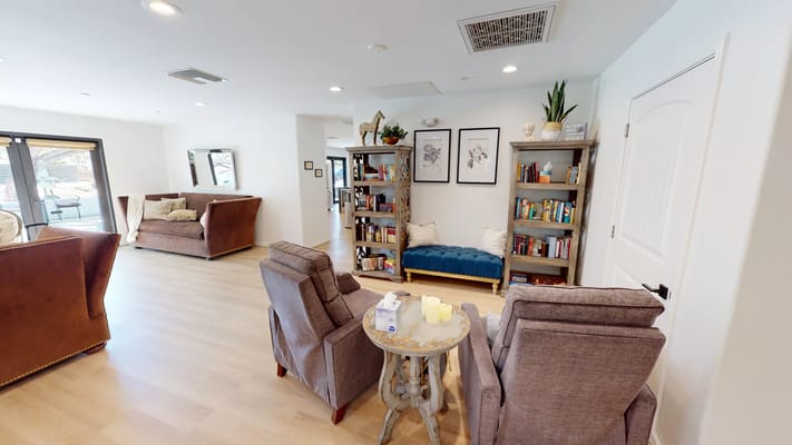 Common area with seating and bookshelves