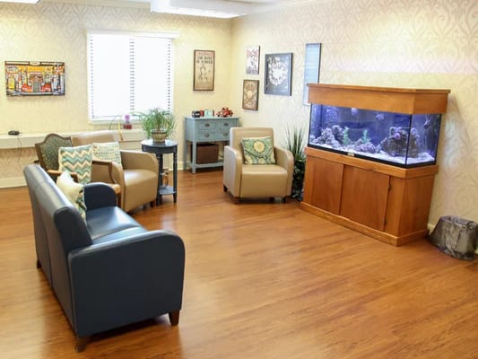 Cozy common area with seating and an aquarium