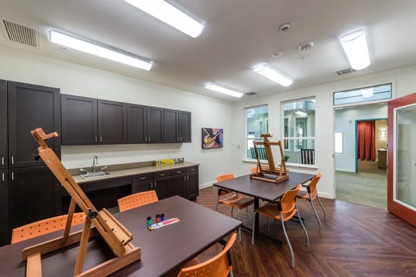 An art activity room with easels and tables