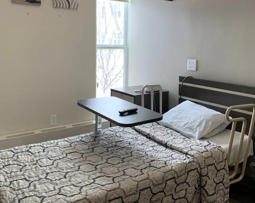 A resident room with a bed and table