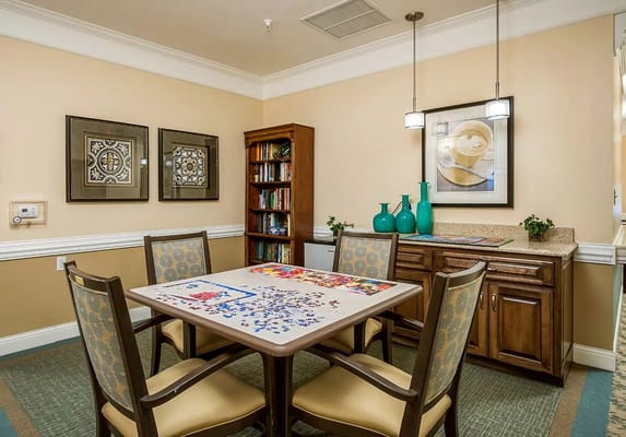 Cozy puzzle room with a table and bookshelves