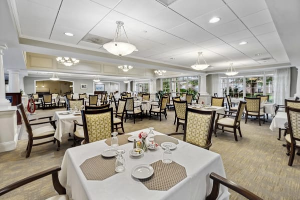 Bright dining room with tables set for meals