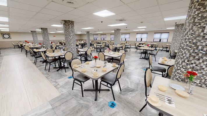 Dining room setup with tables and chairs ready for meals