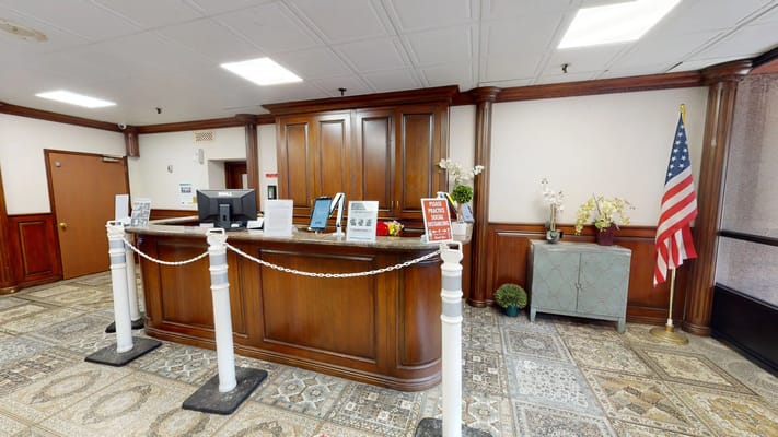 Reception area with wooden counter and American flag
