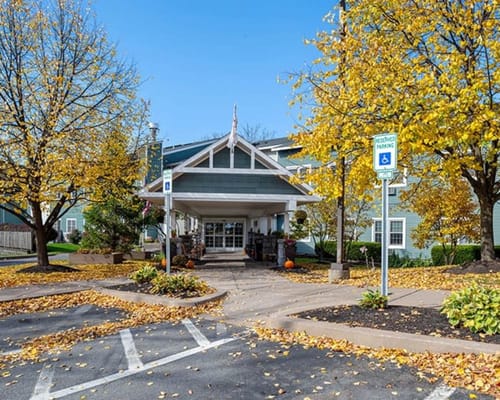 Main entrance of The Hearth on James with autumn foliage