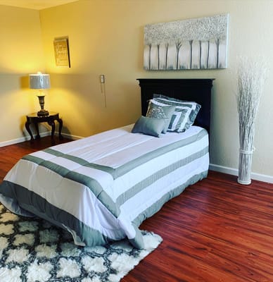 A cozy single bed in a warmly decorated room