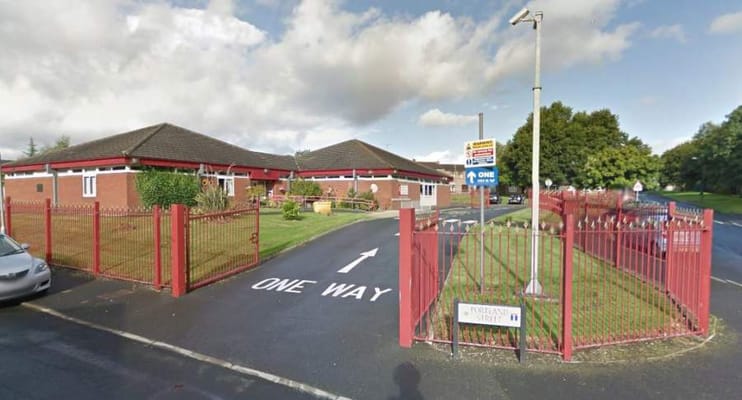 Entrance gate of MHA Portland House with a one-way sign