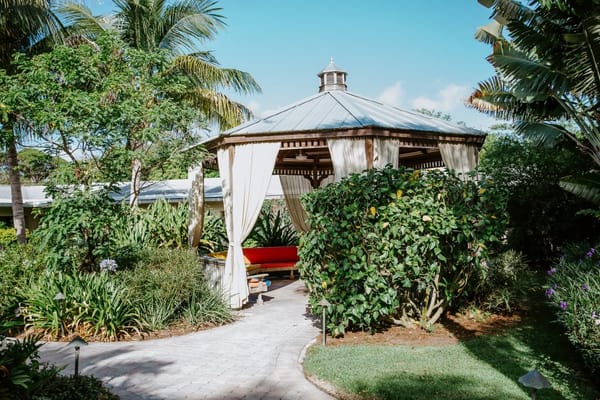 A gazebo in a lush garden area of the facility