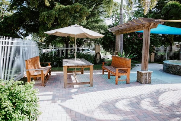 Outdoor seating area with tables and umbrella