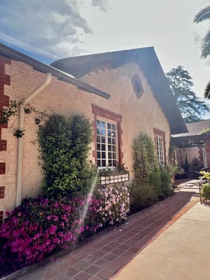 Exterior view of a facility with colorful flowers
