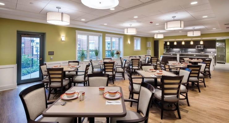 Modern dining area with tables and chairs set for meals