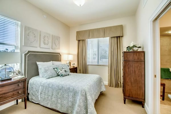 Well-decorated private resident room with a bed and furnishings