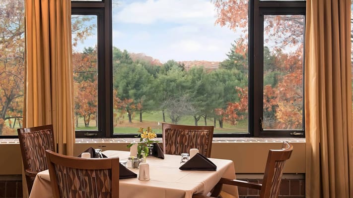 Dining room with a view of autumn trees