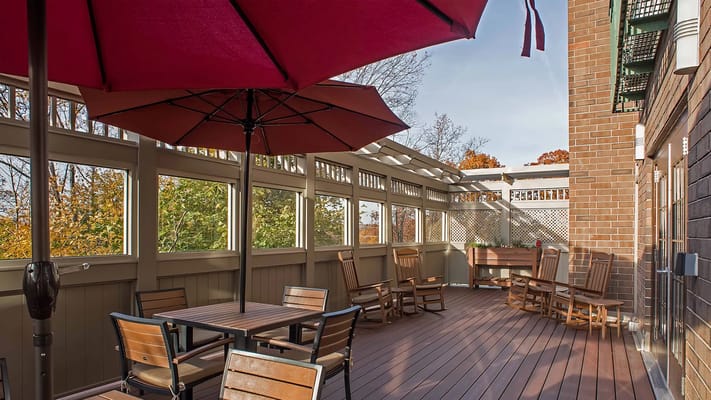 Outdoor seating area with umbrellas and wooden furniture