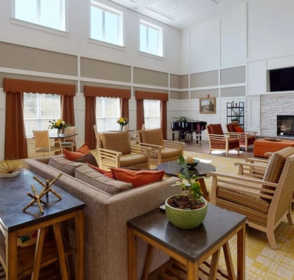 Bright common area with seating and piano