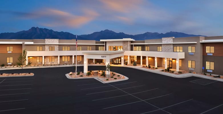 Exterior view of a modern assisted living facility at dusk