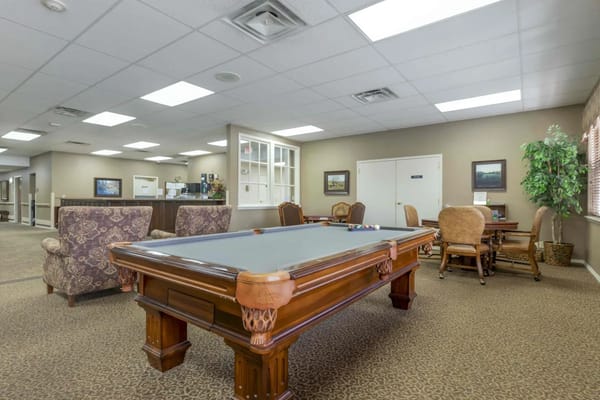Interior common area with billiards table and seating