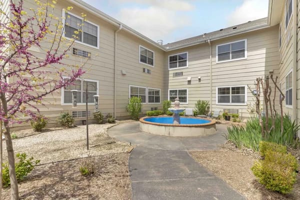 Outdoor courtyard with a fountain and landscaping