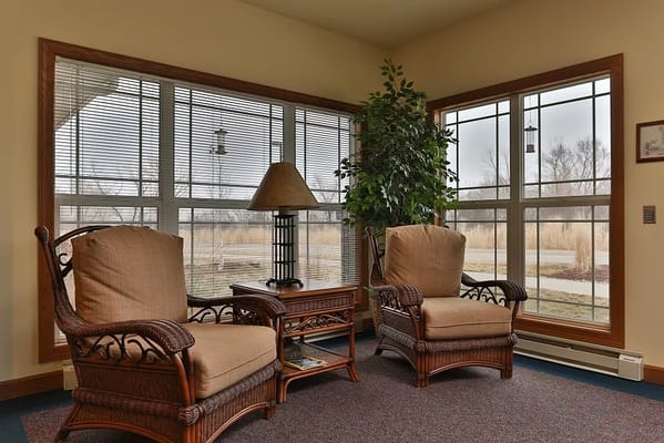 Cozy seating area with large windows and plants