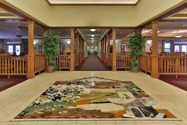 Interior view of a nursing home lobby with mural