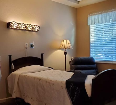 Cozy private resident room with a bed and lamp