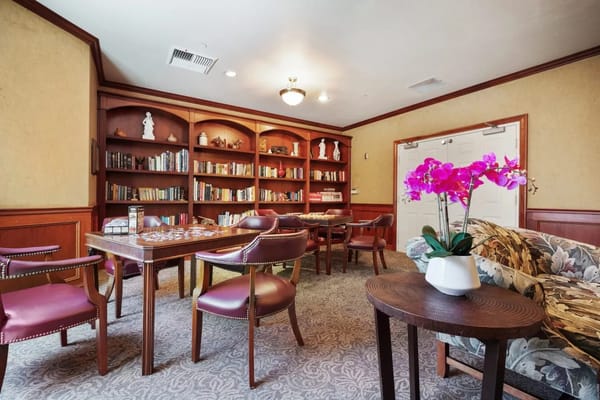 Cozy common area with bookshelves and flowers
