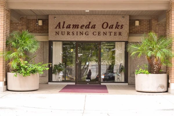 Entrance of Alameda Oaks Nursing Center with greenery