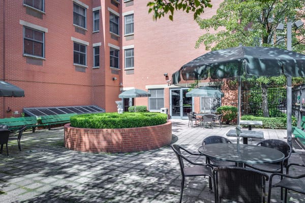 Quiet outdoor seating area with tables and umbrellas