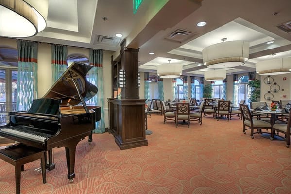 Bright common area with piano and seating