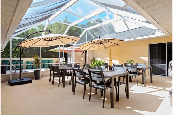 Outdoor patio area with tables and umbrellas