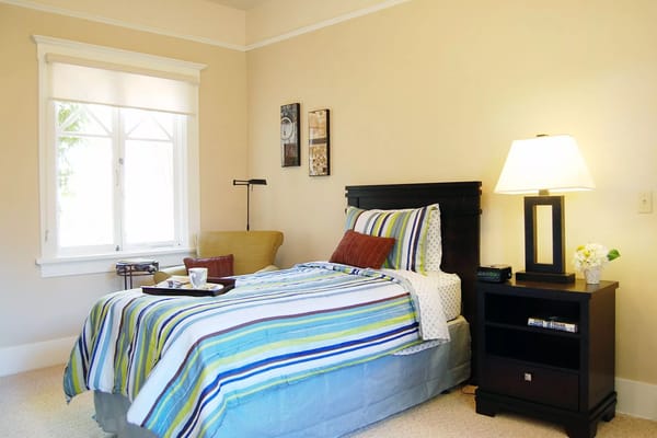 Cozy private resident room with colorful bedding