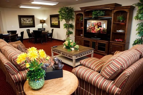 A cozy common area with seating and television