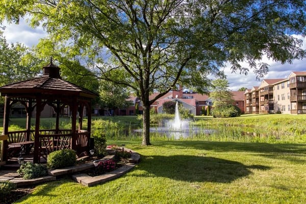 Outdoor gazebo overlooking a pond with fountain