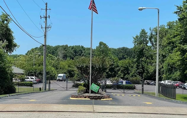 Entryway view with flag and parking area