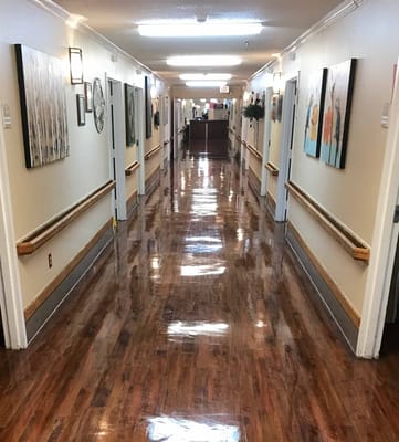 Interior hallway with artwork and polished floor