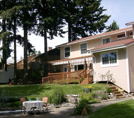 Exterior view of a senior living facility's backyard and building